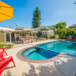 Outdoor photo showing the pool, spa, and built in bbq